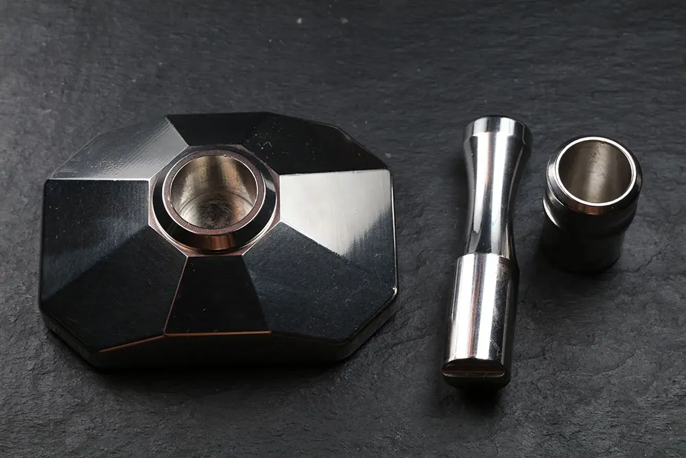The base with the cup seated in it, the pestle and a spare cup alongside